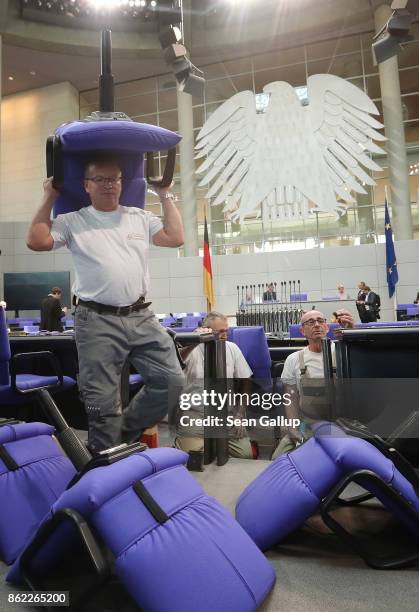 Workers install new seats and working spaces for parliamentarians in the Bundestag at the Reichstag on October 17, 2017 in Berlin, Germany. Following...