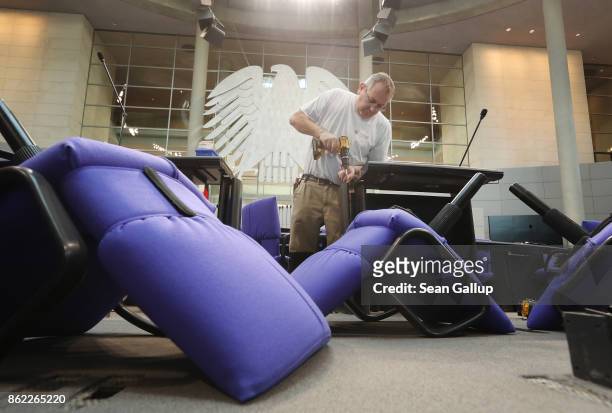 Workers install new seats and working spaces for parliamentarians in the Bundestag at the Reichstag on October 17, 2017 in Berlin, Germany. Following...