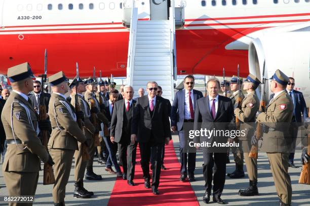 Turkish President Recep Tayyip Erdogan is welcomed by Turkey's Ambassador to Warsaw Tahsin Tunc Ugdul, Polish Ambassador to Ankara Maciej Lang and...