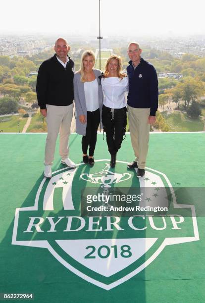 Thomas Bjorn, Captain of Europe and girlfriend Grace Barber and Jim Furyk, Captain of The United States and wife Tabitha pose on a platform on the...