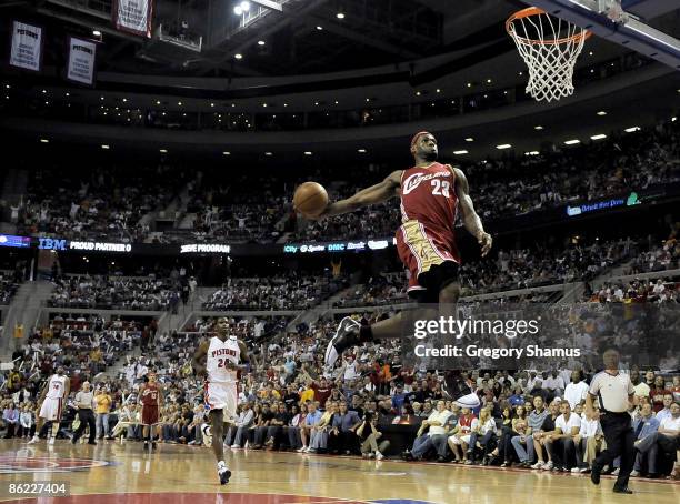 LeBron James of the Cleveland Cavaliers gets in for a first quarter break away dunk in front of Antonio McDyess of the Detroit Pistons in Game Four...