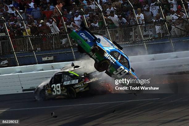 Carl Edwards, driver of the Claritin Ford goes airborne as Ryan Newman, driver of the Stewart-Haas Racing Chevrolet hits the wall at the end of the...