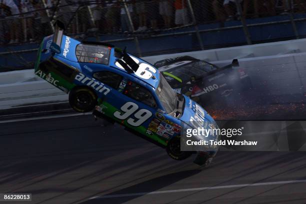 Carl Edwards, driver of the Claritin Ford goes airborne as Ryan Newman, driver of the Stewart-Haas Racing Chevrolet hits the wall at the end of the...