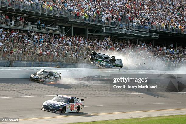 Carl Edwards, driver of the Claritin Ford, goes airborne as Ryan Newman, driver of the Steweart-Haas Racing Chevrolet suffers damage and Dale...