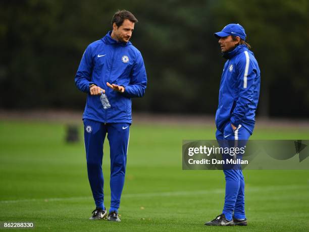Antonio Conte, Manager of Chelsea and coach Carlo Cudicini in discussion during a Chelsea training session on the eve of their UEFA Champions League...