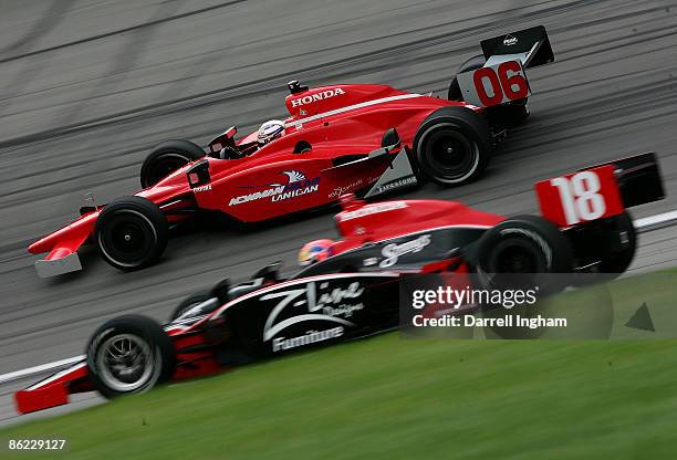 Robert Doornbos drives the Newman Haas Lanigan Racing Dallara Honda past Justin Wilson in the Dale Coyne Racing Dallara Honda during the IRL IndyCar...
