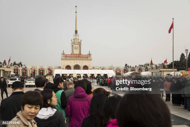 Visitors line up outside the Beijing Exhibition Center for the "Five Years of Sheer Endeavor" exhibition in Beijing, China, on Tuesday, Oct. 17,...