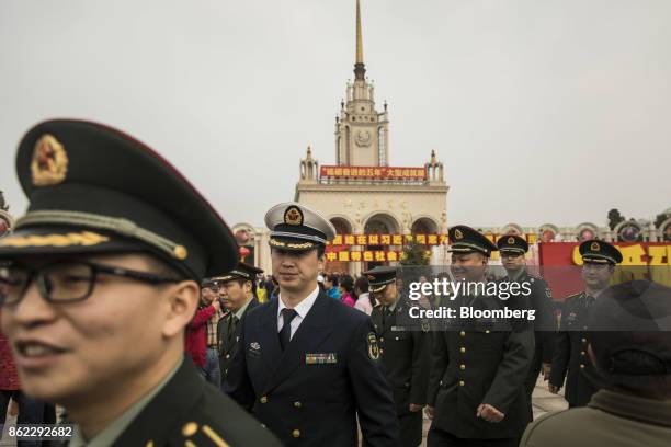 Members of the Chinese People's Liberation Army line up outside the Beijing Exhibition Center for the "Five Years of Sheer Endeavor" exhibition in...