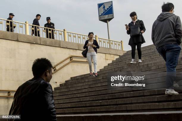Visitors walk down a flight of steps to a pedestrian tunnel at Tiananmen Square in Beijing, China, on Monday, Oct. 16, 2017. President Xi Jinping is...