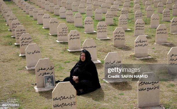 An Iraqi Kurdish woman visits the grave of her relative, Hafkar Omar Mustafa who was killed in a gas attack by former Iraqi president Saddam Hussein...