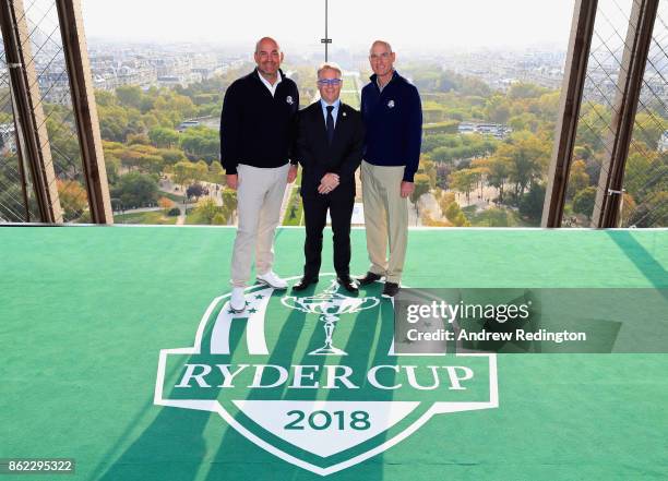 Jim Furyk, Captain of The United States and Thomas Bjorn, Captain of Europe pose with PGA European Tour CEO Keith Pelley on a platform on the Eiffel...