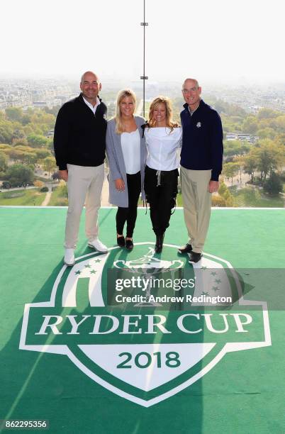 Thomas Bjorn, Captain of Europe and girlfriend Grace Barber and Jim Furyk, Captain of The United States and wife Tabitha pose on a platform on the...