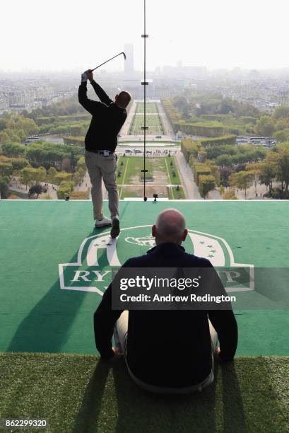 Thomas Bjorn, Captain of Europe tee off from a platform on the Eiffel Tower as Jim Furyk, Captain of The United States looks on during the Ryder Cup...