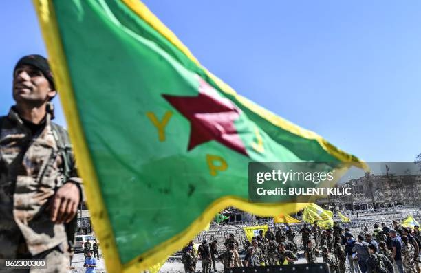 Fighter of the Syrian Kurdish People's Protection Units , a member group under the umbrella of the Syrian Democratic Forces , backed by US special...