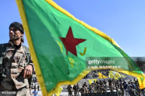 Fighter of the Syrian Kurdish People's Protection Units , a member group under the umbrella of the Syrian Democratic Forces , backed by US special...