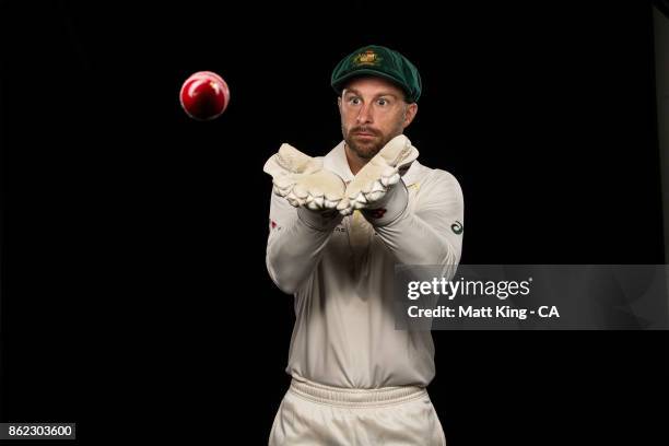 Matthew Wade of Australia poses catching a red ball during the Australia Test cricket team portrait session at Intercontinental Double Bay on October...