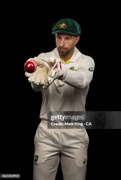 Matthew Wade of Australia poses catching a red ball during the Australia Test cricket team portrait session at Intercontinental Double Bay on October...