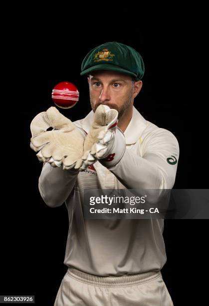Matthew Wade of Australia poses catching a red ball during the Australia Test cricket team portrait session at Intercontinental Double Bay on October...