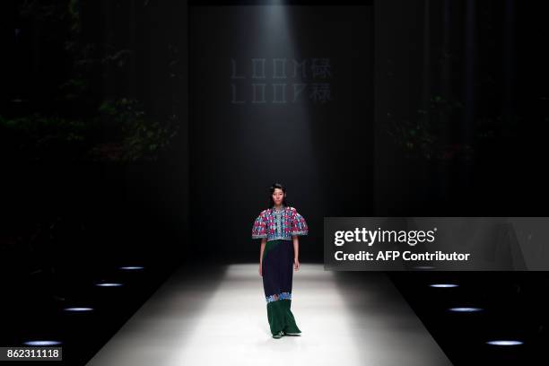 Model displays a creation of Loom Loop from Hong Kong, designed by Polly Ho, during the Amazon Fashion Week Tokyo 2018 spring/summer collection in...