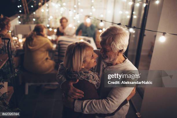 at our anniversary party - couple celebrating imagens e fotografias de stock