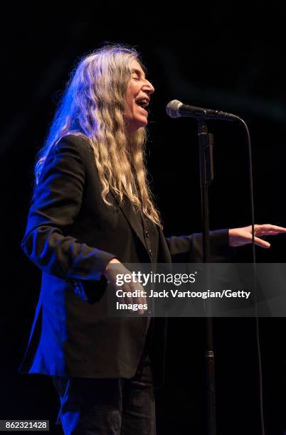 American Rock musician and poet Patti Smith leads her band during a tribute to her late husband, guitarist Fred 'Sonic' Smith, at Central Park...