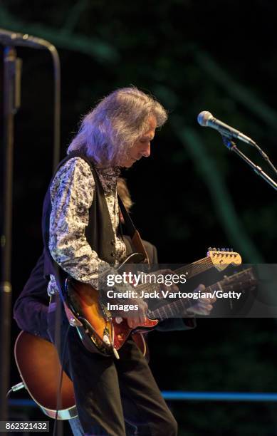 American Rock musician Lenny Kaye plays guitar as he performs with Patti Smith's band during a tribute to Smith's late husband , guitarist Fred...