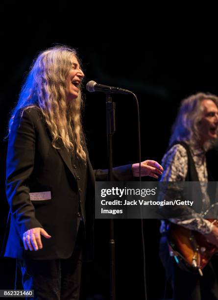 American Rock musician and poet Patti Smith leads her band during a tribute to her late husband, guitarist Fred 'Sonic' Smith, at Central Park...