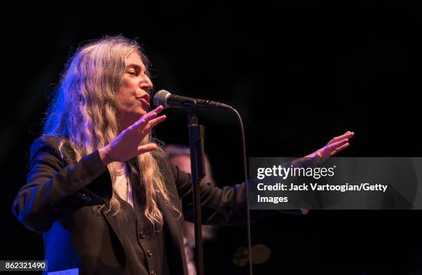 American Rock musician and poet Patti Smith leads her band during a tribute to her late husband, guitarist Fred 'Sonic' Smith, at Central Park...