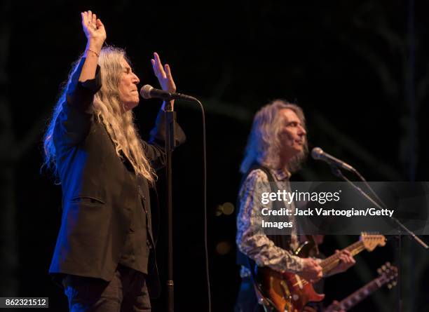 American Rock musician and poet Patti Smith leads her band during a tribute to her late husband, guitarist Fred 'Sonic' Smith, at Central Park...