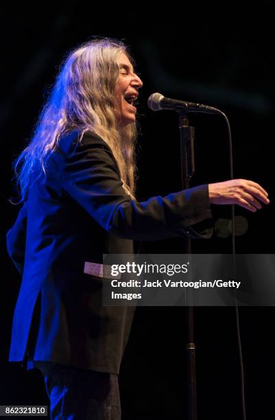 American Rock musician and poet Patti Smith leads her band during a tribute to her late husband, guitarist Fred 'Sonic' Smith, at Central Park...