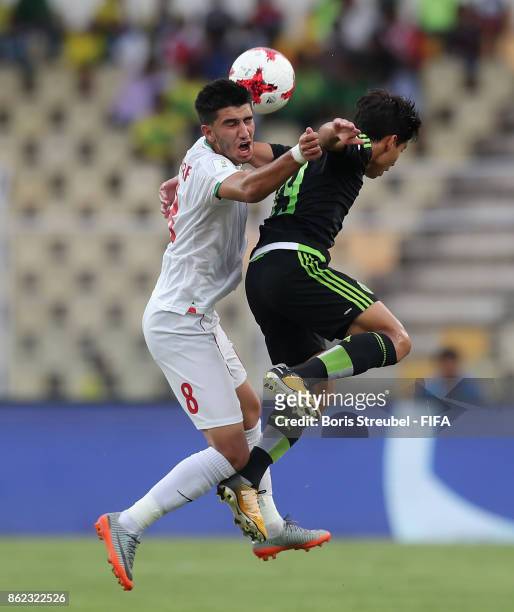 Mohammad Sharifi of Iran jumps for a header with Haret Ortega of Mexico during the FIFA U-17 World Cup India 2017 Round of 16 match between Iran and...