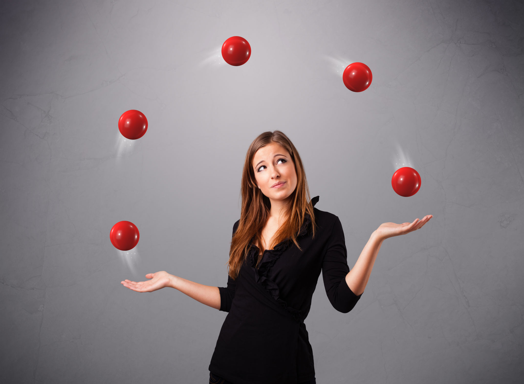 young girl standing and juggling with red balls young girl standing and juggling with red balls