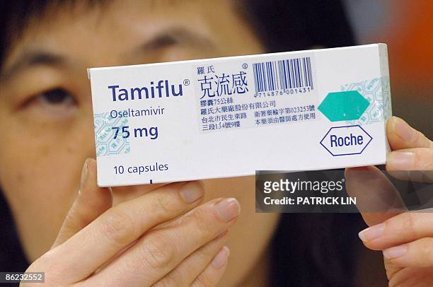 Pharmacist displays a box of the antiviral drug Tamiflu in Taipei on April 27 a medication reported to be effective in treating cases of swine flu....