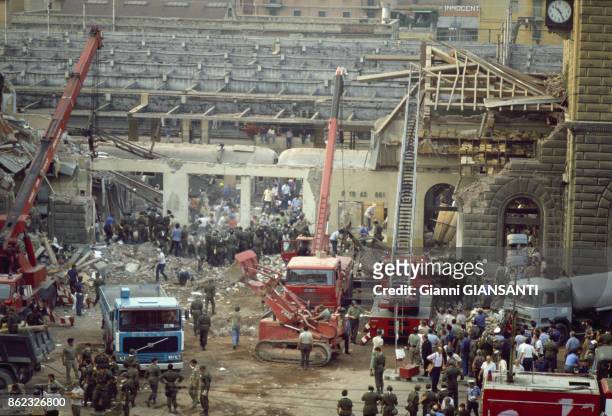 Rescue workers look through the rubble of the train station in Bologna, Italy, after a bomb exploded in the second class waiting room, resulting in...