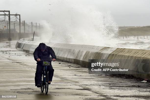 Waves crash over the breakwater as the remnants of Hurricane Ophelia hit Saltcoats on the west coast of Scotland on the morning of 17th October 2017....