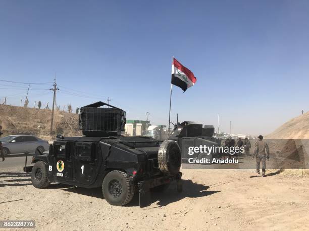 Iraqi forces take security measurements at the controls points as vehicles are seen on their way back to Kirkuk after Iraqi forces retake the control...