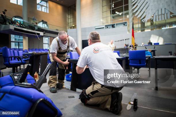 Workers install new seats and working spaces for parliamentarians in the Bundestag at the Reichstag on October 17, 2017 in Berlin, Germany. Following...