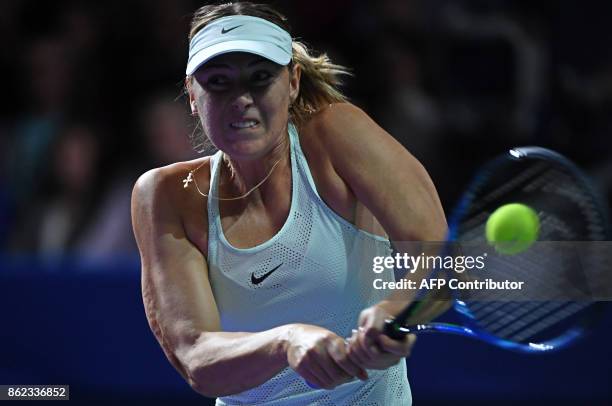 Russia's Maria Sharapova returns the ball to Slovakia's Magdalena Rybarikova during the women's singles first round tennis match at the Kremlin Cup...