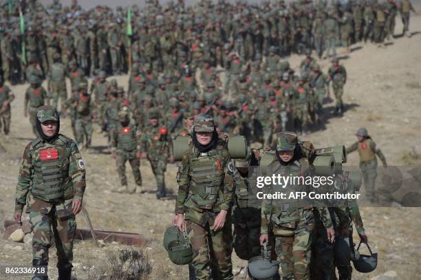 Female Afghan National Army soldiers walk during a military exercise at the Kabul Military Training Centre on the outskirts of Kabul on October 17,...