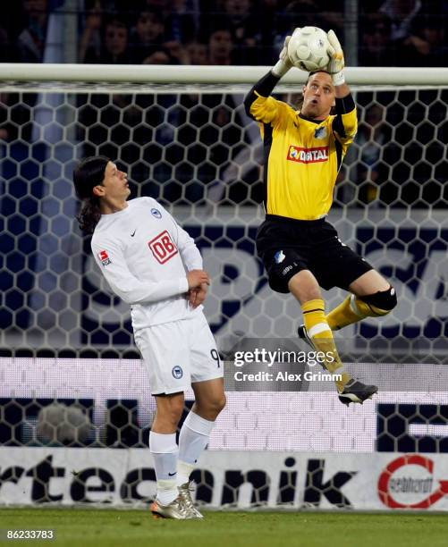 Goalkeeper Timo Hildebrand of Hoffenheim catches the ball ahead of Marko Pantelic of Berlin during the Bundesliga match between TSG 1899 Hoffenheim...