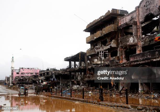 Soldiers walk through a battle damaged street in Marawi City in the Southern Philippines on October 17, 2017. President Rodrigo Duterte on Tuesday...