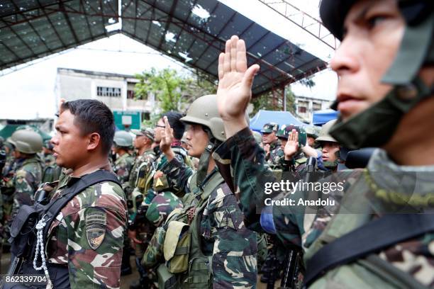 Soldiers, along with President Rodrigo Duterte, pledge to the Philippine flag in Marawi City in the Southern Philippines on October 17, 2017. Duterte...