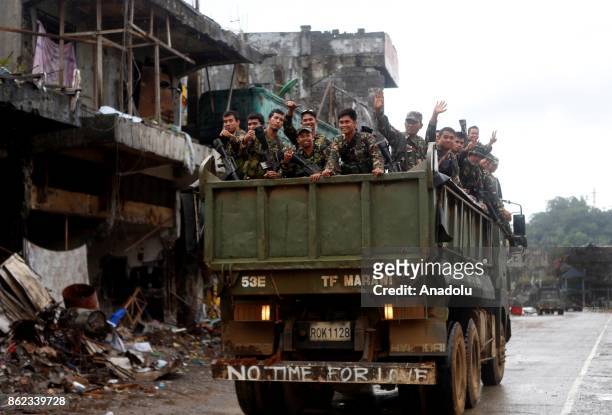Soldiers on a military vehicle are seen on battle damaged street in Marawi City in the Southern Philippines on October 17, 2017. President Rodrigo...