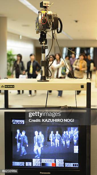 Thermographic device checks the body temperatures of travellers arriving from overseas at a quarantine station at Narita International Airport in...