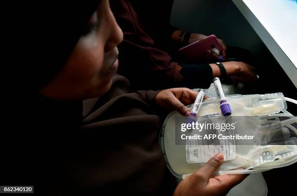 Kenyan women from Somalia, queue to donate blood at Eastleigh in Nairobi on October 17 for the victims of a massive truck bomb in Mogadishu that...