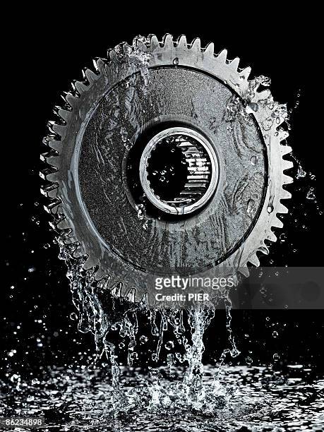 liquid / oil dripping from large steel gear / cog - steel pier stock pictures, royalty-free photos & images