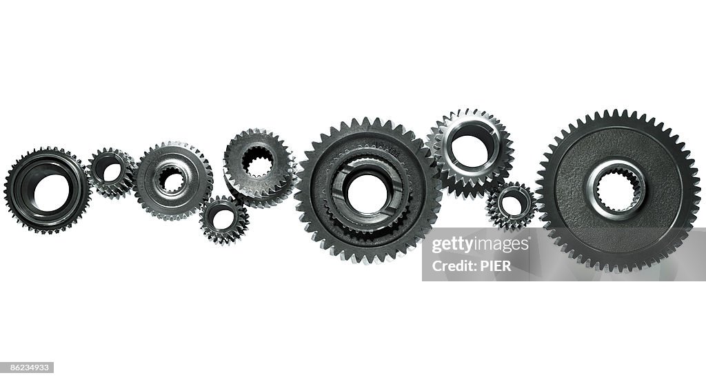 Close-up of a line of linked steel gears / cogs