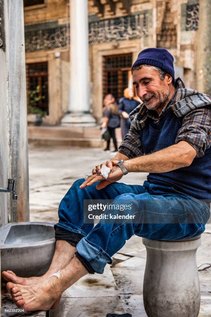 A Muslim Is Preparing For Prayer In The New Mosque Fountain.l