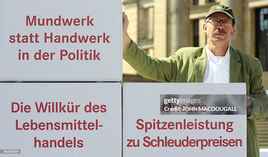 A protester stands next to a "pyramid of