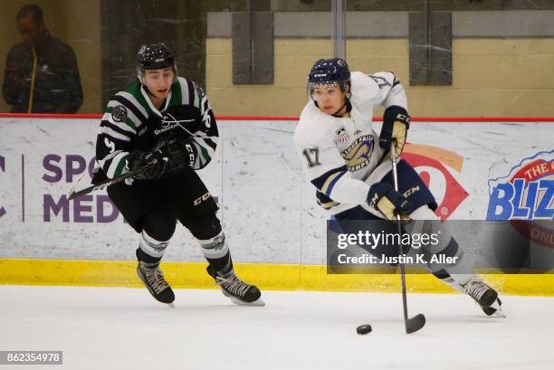 Colin Swoyer of the Sioux Falls Stampede skates with the puck against Steven Agriogianis of the Cedar Rapids RoughRiders during the game on Day 2 of...